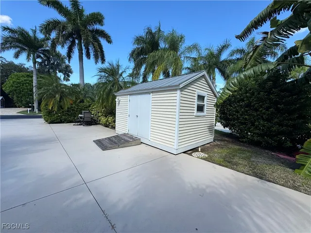 a view of a house with a yard and potted plants