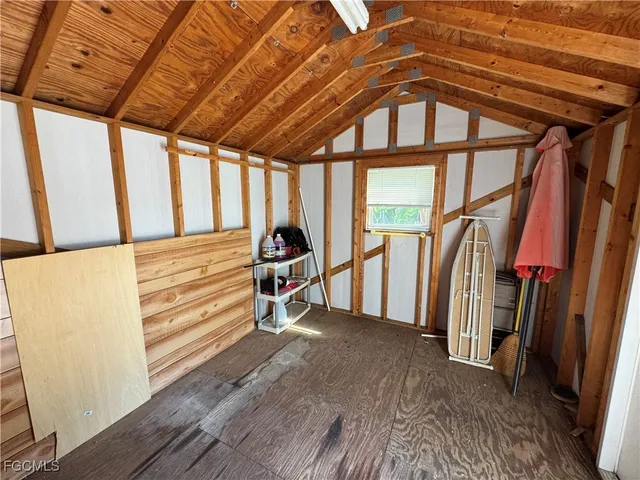 a view of empty room with wooden floor and furniture