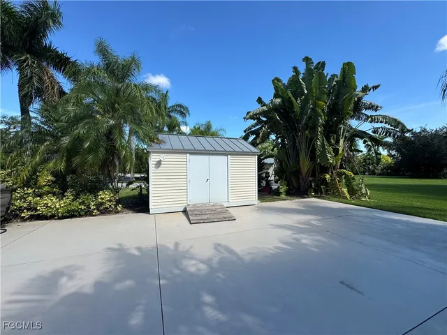 a white house with palm tree in front of it