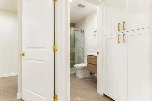 a bathroom with a granite countertop toilet