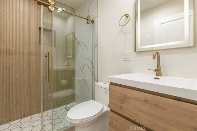 a bathroom with a sink toilet and shower