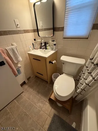 a bathroom with a sink toilet and mirror