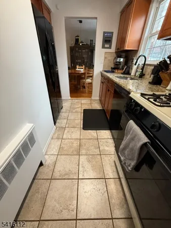 a kitchen with a stove a sink and a refrigerator