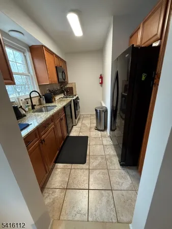 a kitchen with a sink a refrigerator and a stove