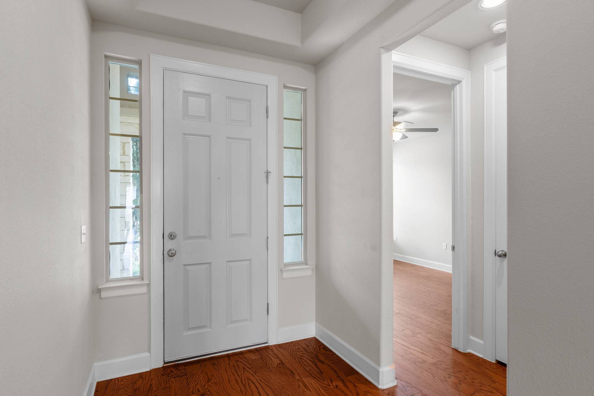 3516 Venezia View Leander, TX 78641 - Photo 13 of 40 Foyer entrance featuring dark wood finished floors, healthy amount of natural light, and ceiling fan