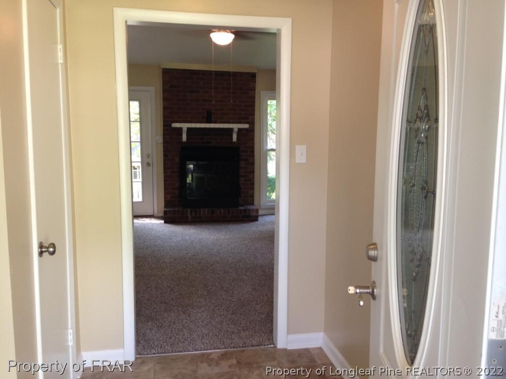3320 Red Fox Road Spring Lake, NC 28390 - Photo 2 of 19 a view of a hallway with wooden floor and a hallway