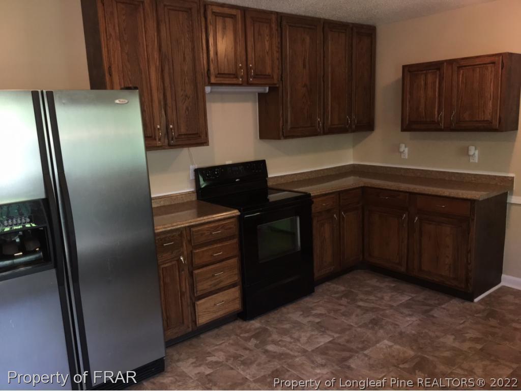 3320 Red Fox Road Spring Lake, NC 28390 - Photo 5 of 19 a kitchen with stainless steel appliances granite countertop a refrigerator and a sink