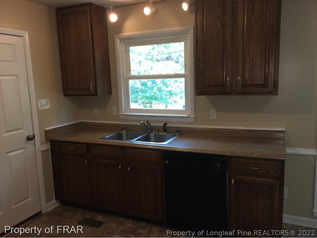 3320 Red Fox Road Spring Lake, NC 28390 - Photo 6 of 19 a kitchen with a sink window and cabinets