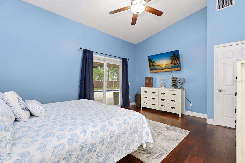 7432 Sparkling Lake Road Orlando, FL 32819 - Photo 24 of 54 a bedroom with a bed and a tv on dresser