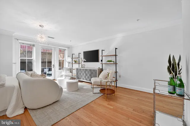 a living room with furniture wooden floor and a flat screen tv