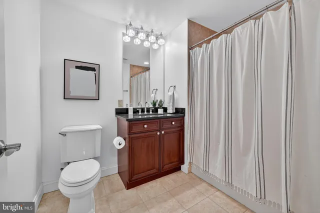 a bathroom with a toilet a sink and a mirror