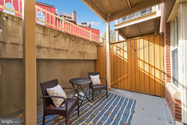 a view of a chairs and table in the balcony