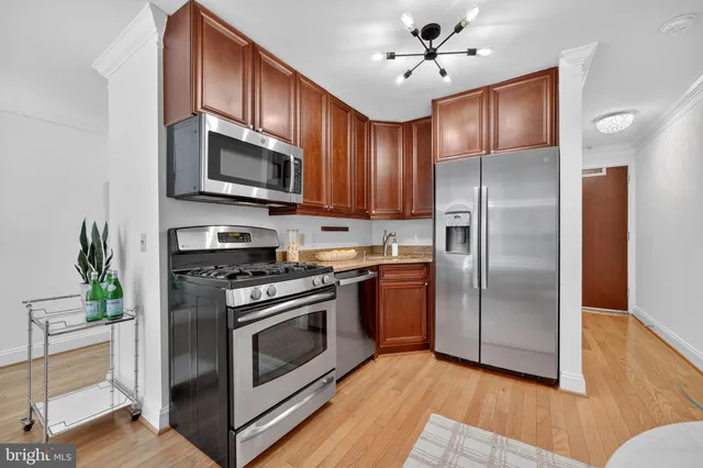 a kitchen with stainless steel appliances granite countertop a stove a refrigerator and a microwave