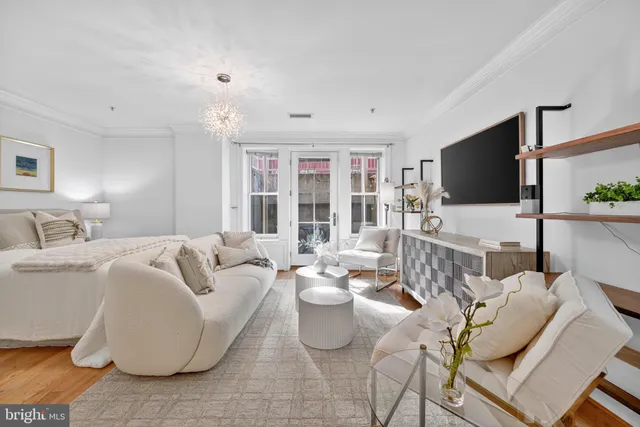 a living room with furniture large window and flat screen tv