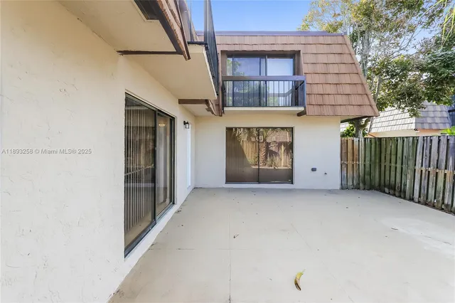 an empty room with white walls and sliding door