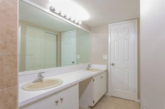 a view of an empty room and chandelier fan