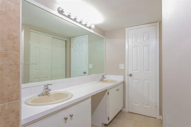 a view of an empty room and chandelier fan