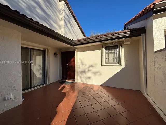 a front view of a house with a large window