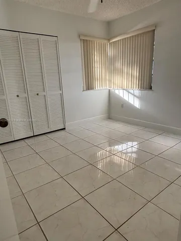 an empty room with windows and entrance