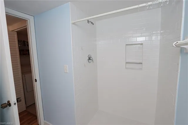 a bathroom with a glass shower door