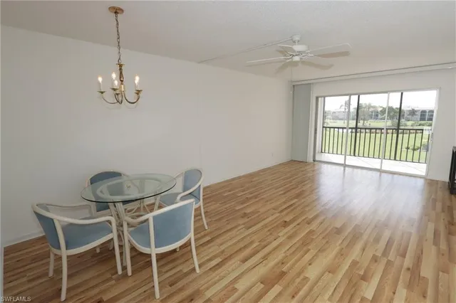 a view of a dining room with furniture wooden floor and chandelier