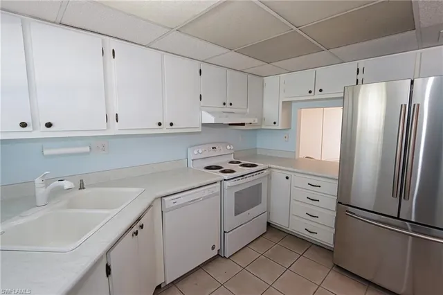 a kitchen with cabinets stainless steel appliances and a sink