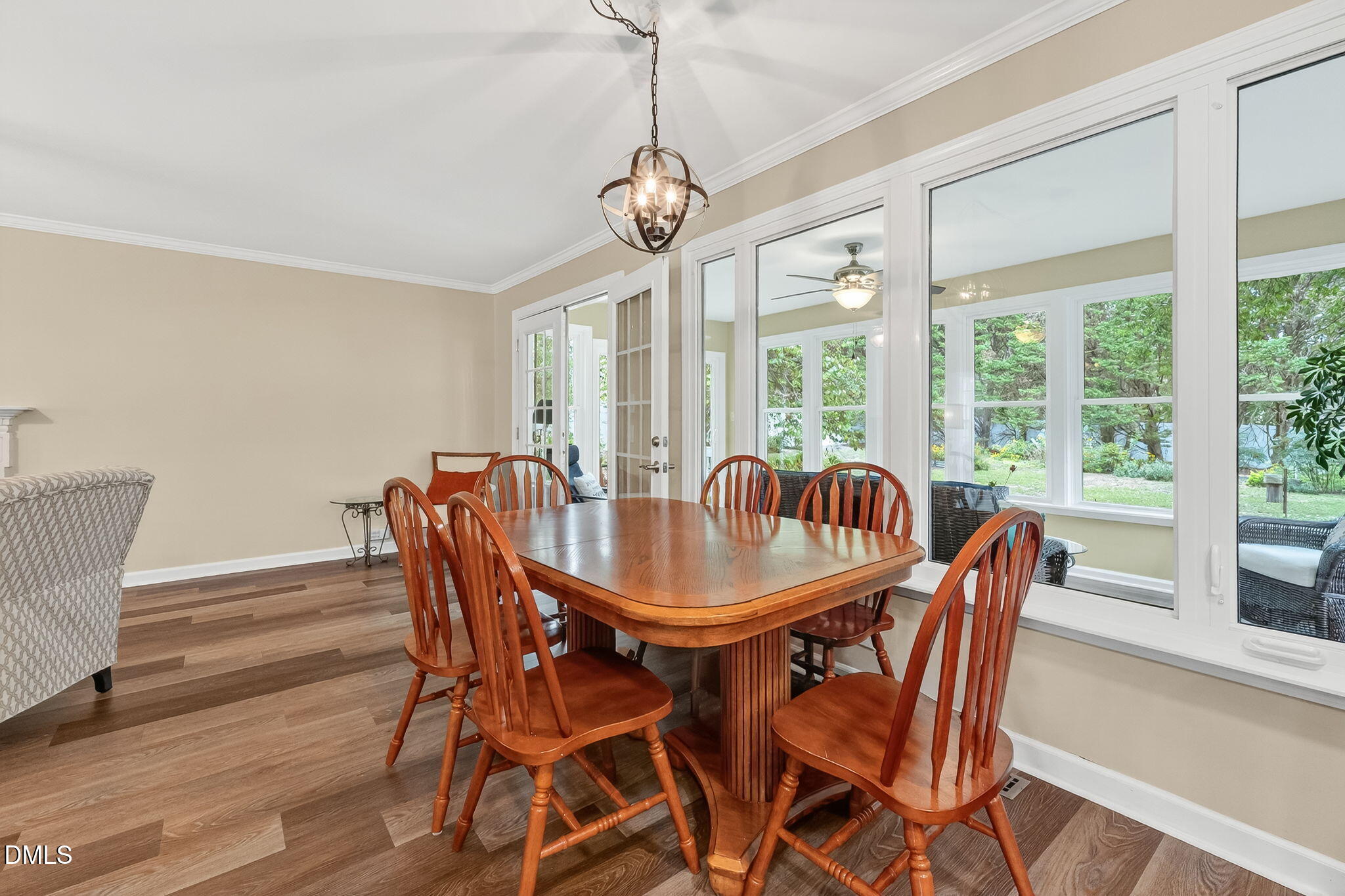 6009 Swales Way Raleigh, NC 27603 - Photo 16 of 59 a dining room with furniture a chandelier and wooden floor