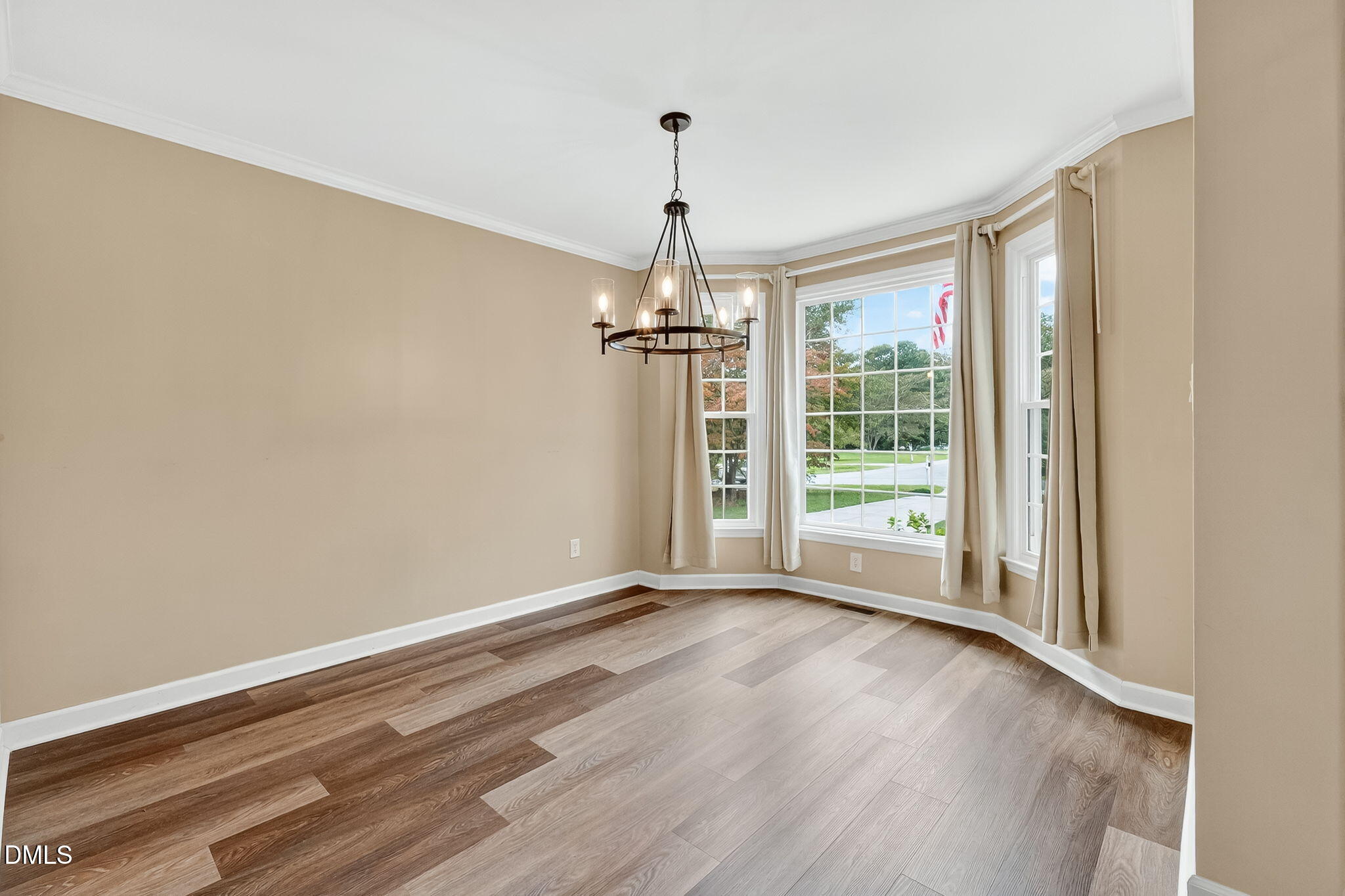 6009 Swales Way Raleigh, NC 27603 - Photo 24 of 59 a view of empty room with wooden floor and fan