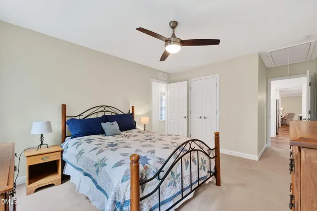 a spacious bathroom with a double vanity sink double mirror and a toilet