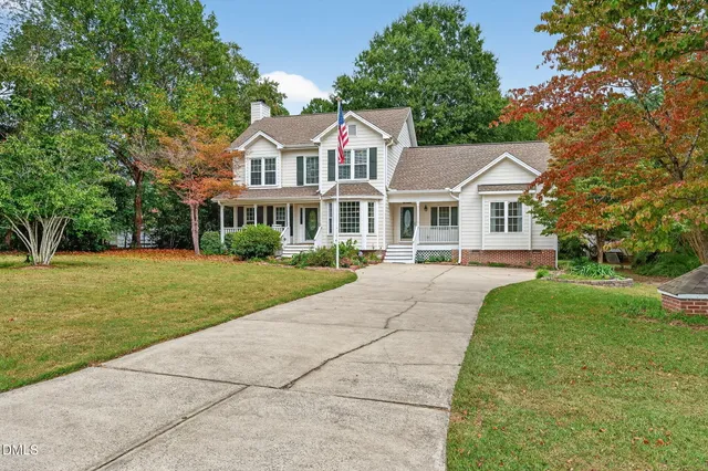 a front view of house with yard and green space