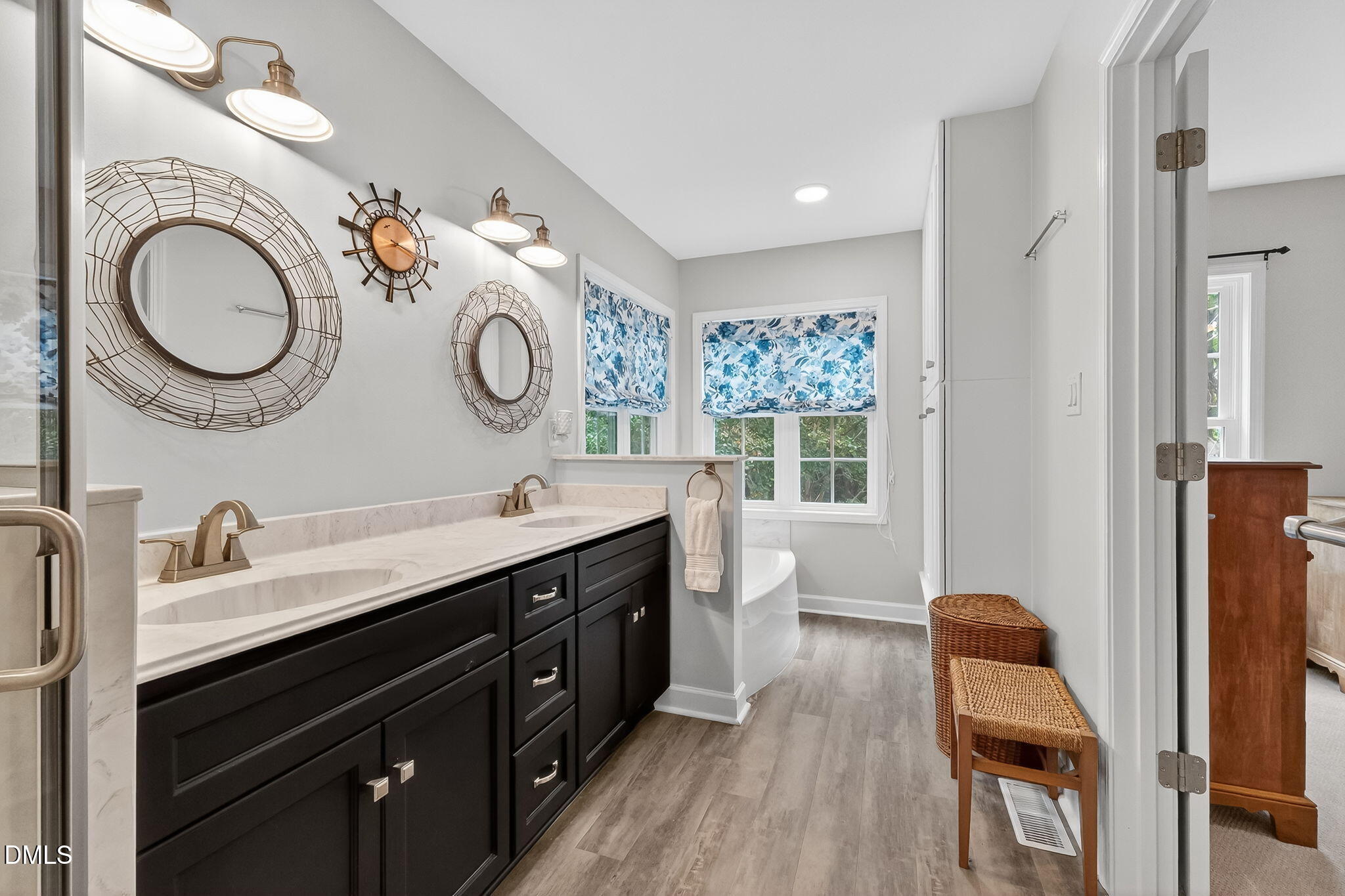 6009 Swales Way Raleigh, NC 27603 - Photo 34 of 59 a spacious bathroom with a double vanity sink double mirror and a toilet