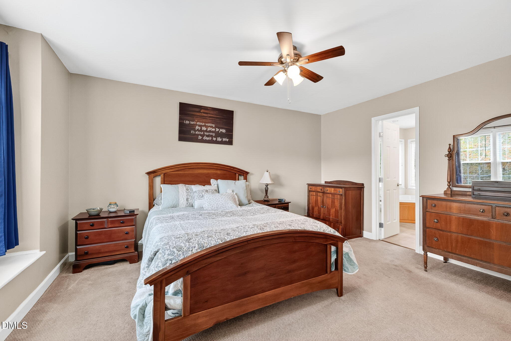 6009 Swales Way Raleigh, NC 27603 - Photo 41 of 59 a bedroom with a bed and a chandelier