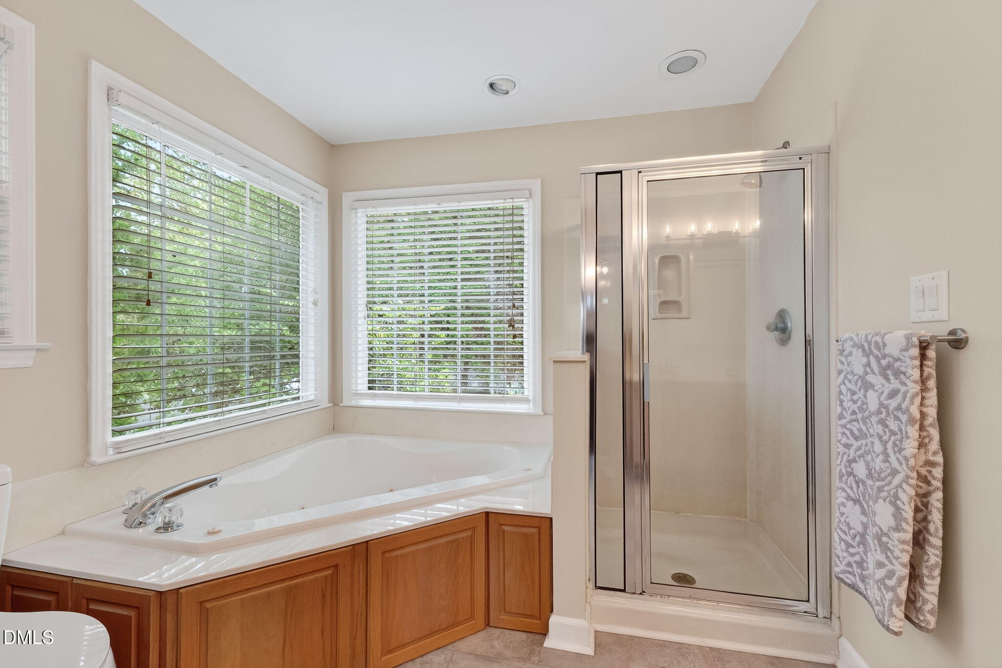 6009 Swales Way Raleigh, NC 27603 - Photo 43 of 59 a bathroom with a tub shower and sink