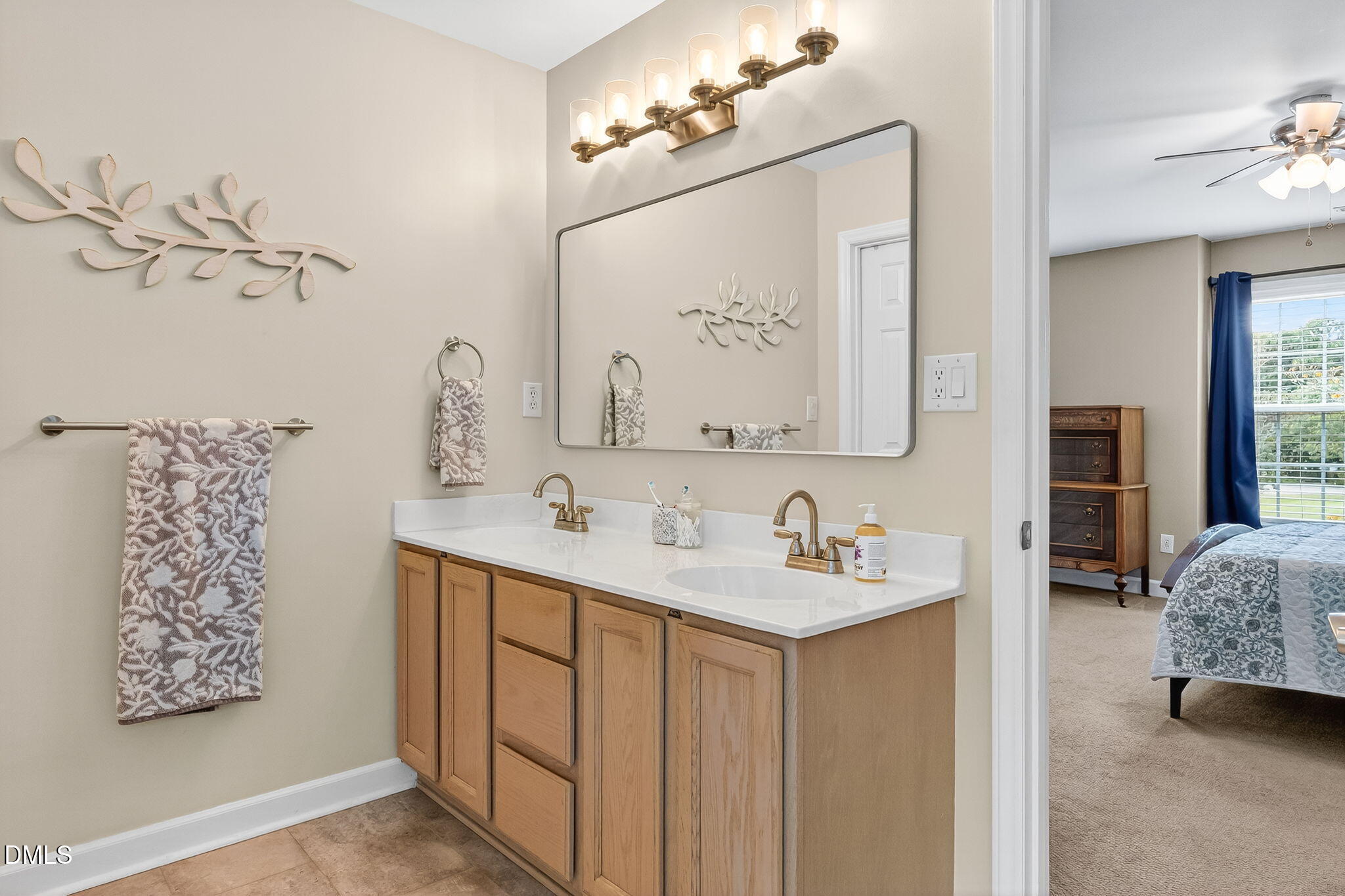 6009 Swales Way Raleigh, NC 27603 - Photo 44 of 59 a en suite bathroom with a double vanity sink mirror and