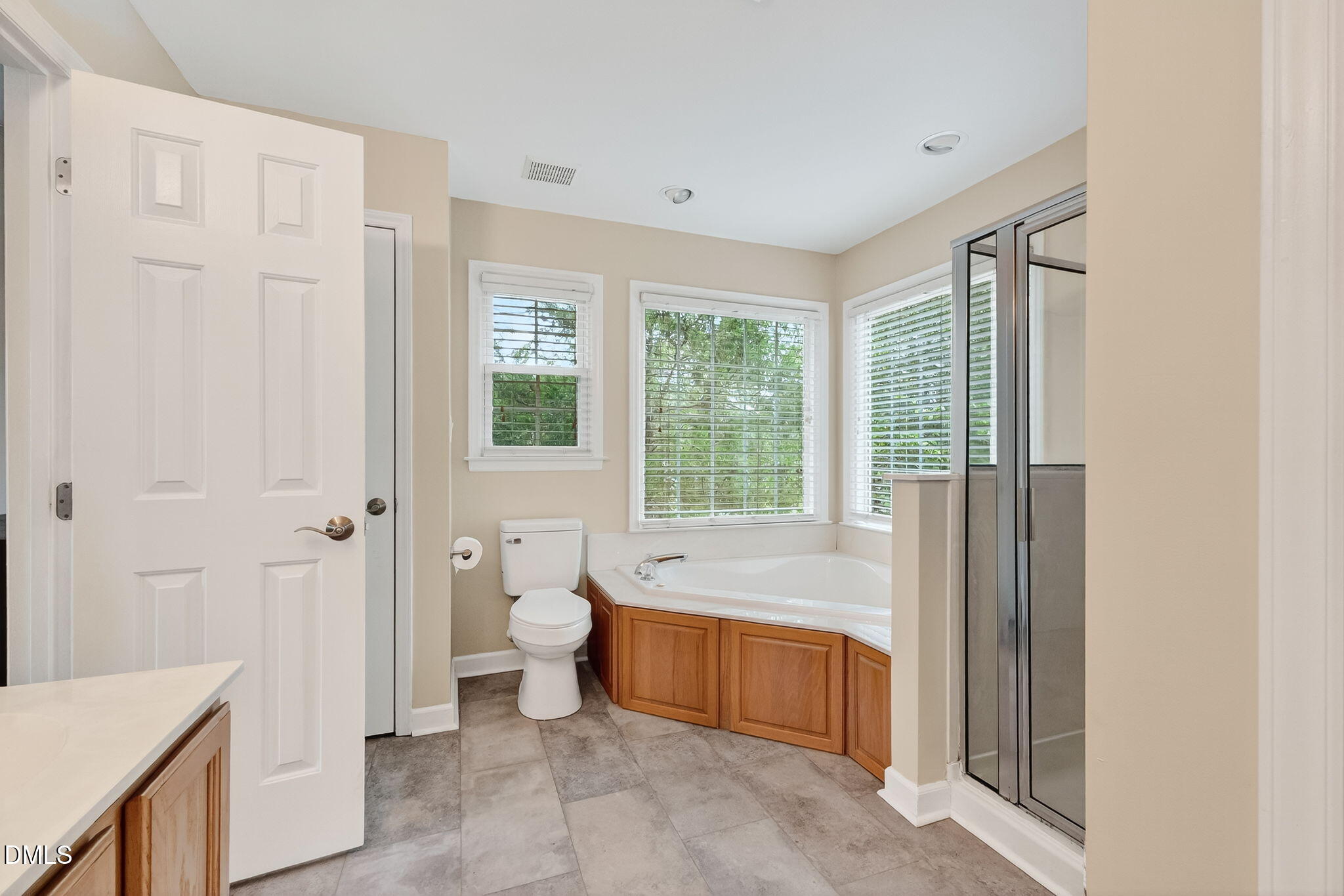 6009 Swales Way Raleigh, NC 27603 - Photo 46 of 59 a spacious bathroom with a tub and a view of bathroom