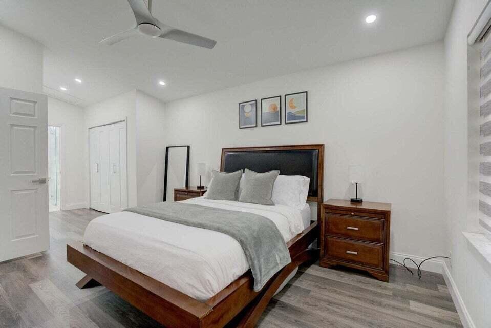 6178 Garrett Street Jupiter, FL 33458 - Photo 11 of 18 a bedroom with a bed and a tv