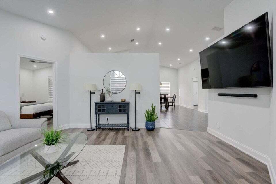 6178 Garrett Street Jupiter, FL 33458 - Photo 5 of 18 a living room with furniture and a flat screen tv