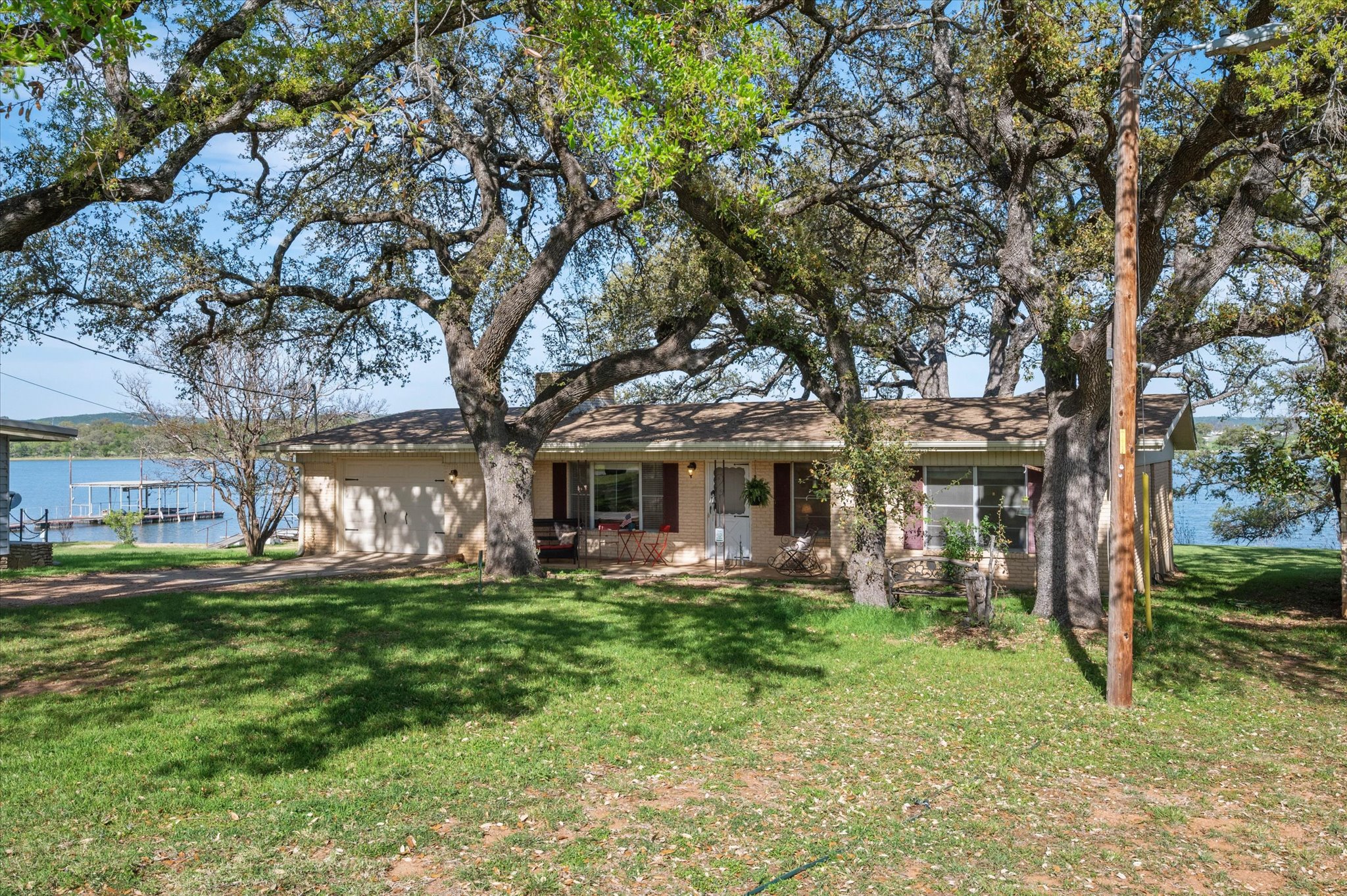210 Lake Loop Tow, TX 78672 - Photo 2 of 28 Mid Century Single Story Waterfront Home with attached and detached garage. Lakefront-Boat Dock and a Walk-out Beachfront in a culdesac.