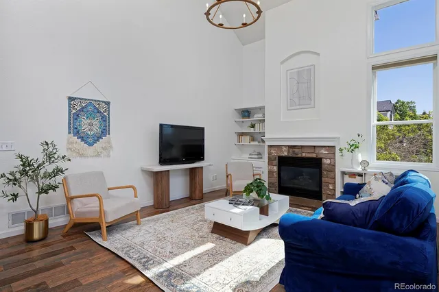 a living room with furniture fireplace and window