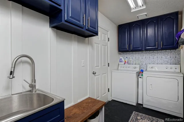 a view of a kitchen with sink and cabinets