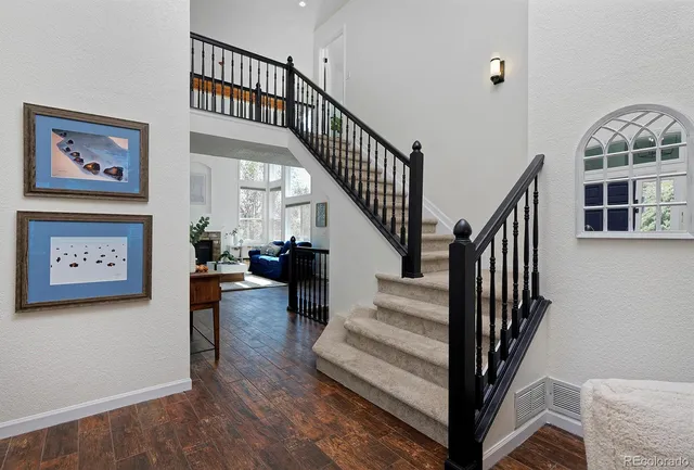 a view of staircase with wooden floor and a rug