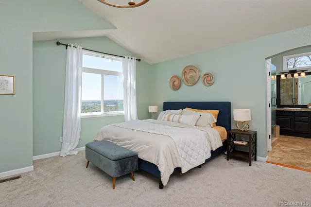 a spacious bedroom with a bed and a window