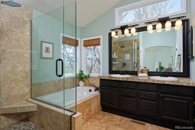 a bathroom with a granite countertop sink mirror and bathtub