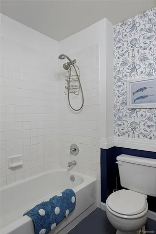 a bathroom with a toilet bathtub and shower
