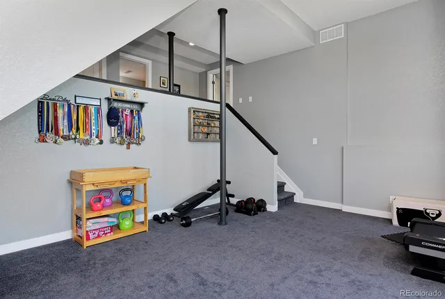 a view of an empty room with window and furniture