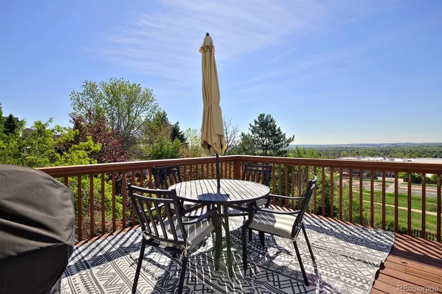 a view of a chair and table on the deck