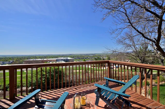 a view of a balcony with wooden floor and fence