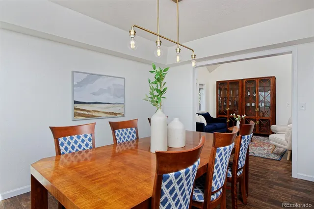 a dining room with furniture and wooden floor