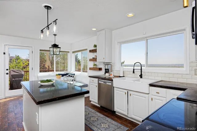 a kitchen with sink stove and cabinets