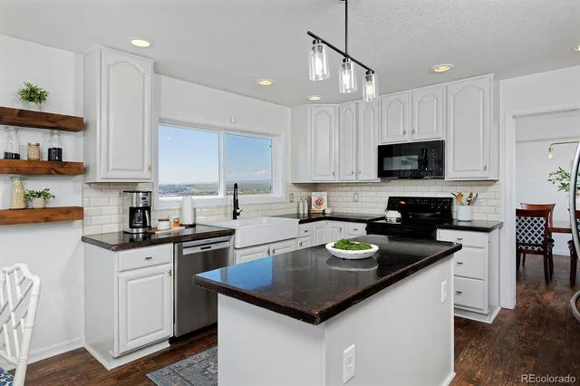 a kitchen with a sink stove top oven and microwave